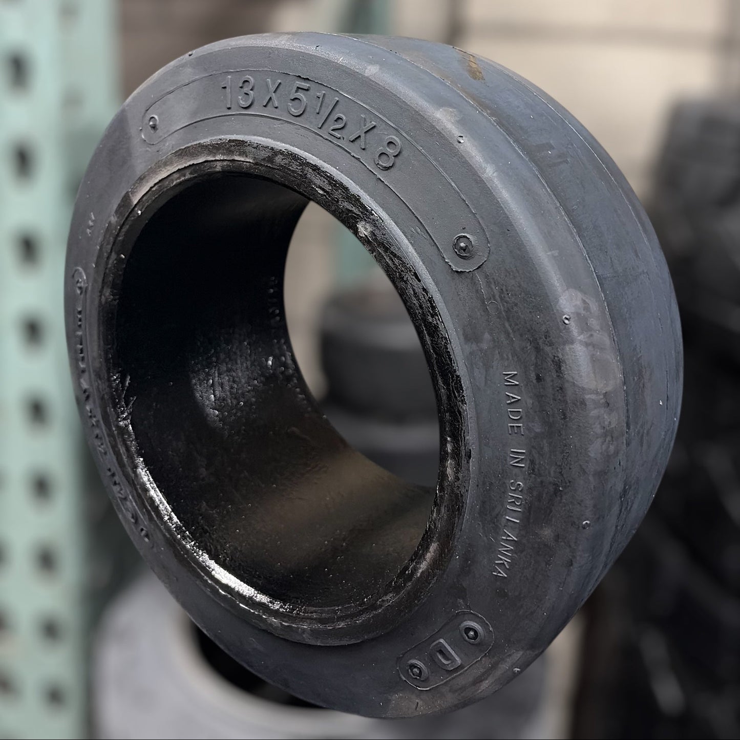 Black rubber wheel or tire component on a blurred background