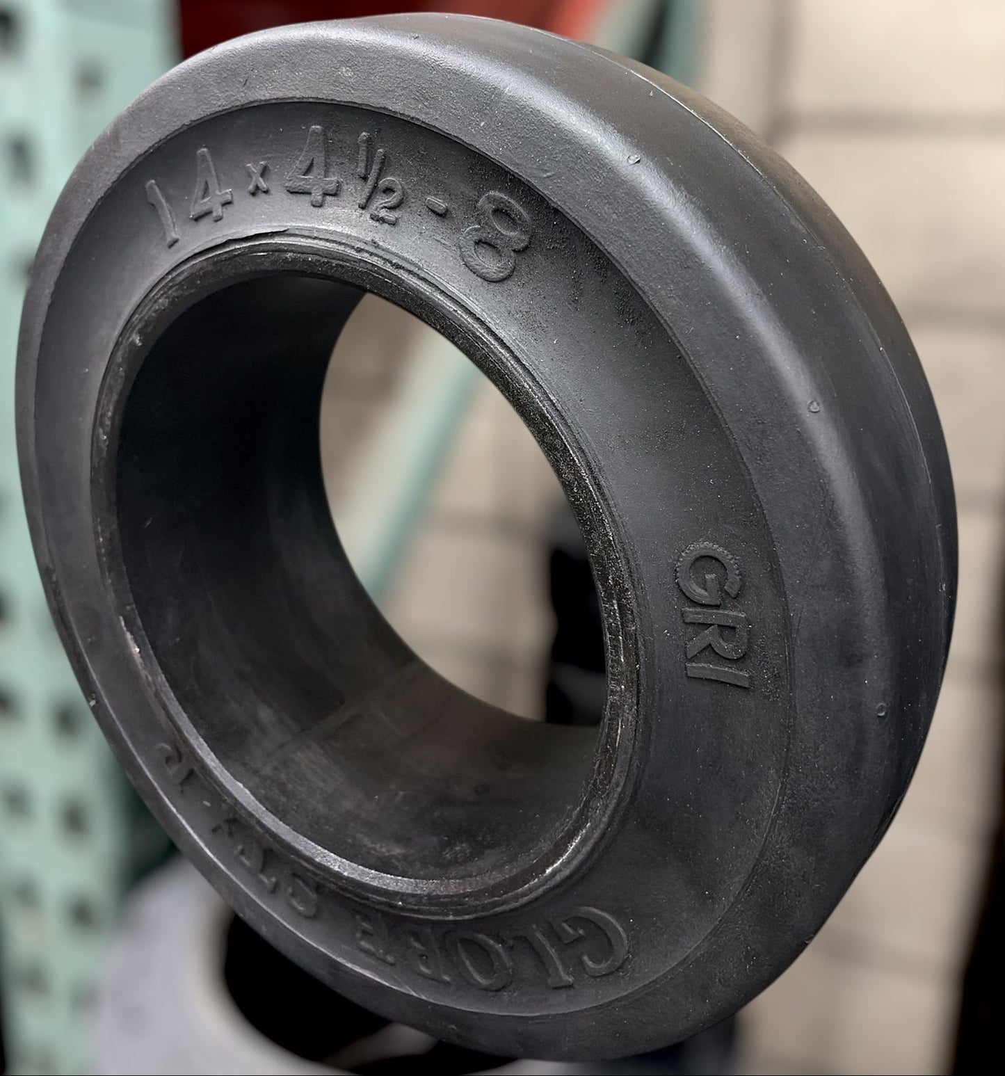 forklift tire with engraved measurements in a warehouse setting