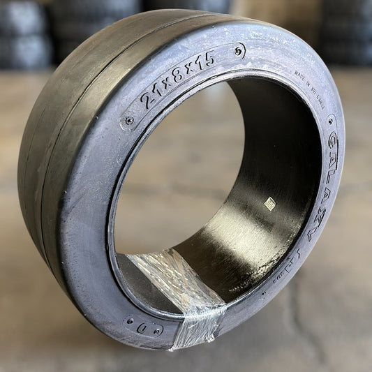 21x8x15 smooth cushion forklift tire in warehouse with additional tire in the background