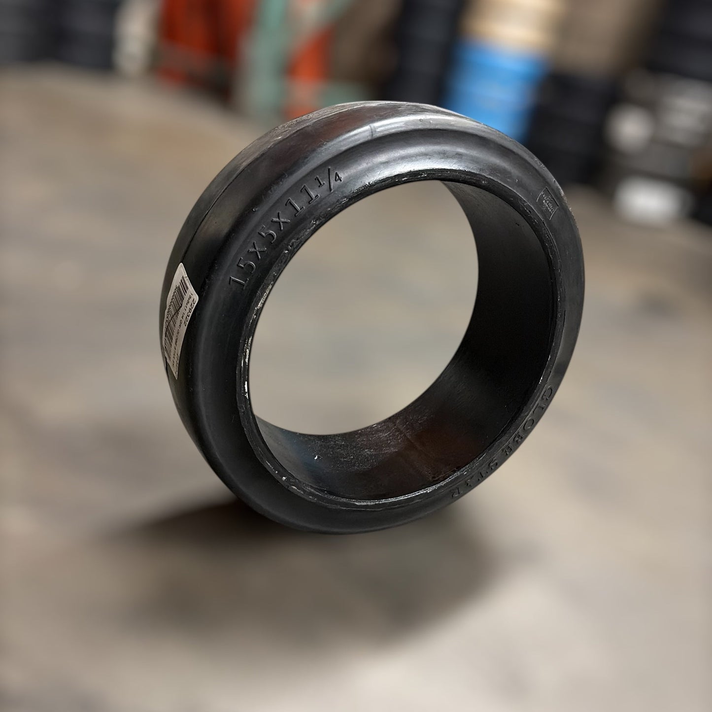 15x5x11.25smooth warehouse forklift press on cushion tire blurred backgorund