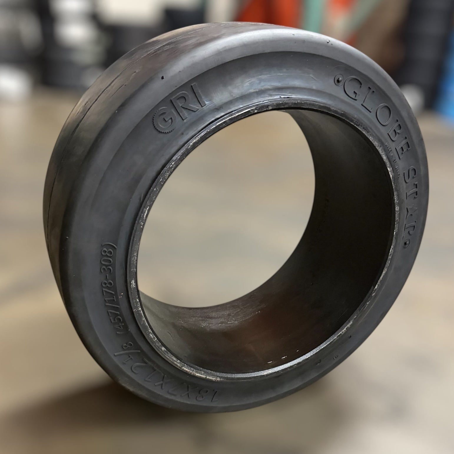 18x7x12.125 Smooth rubber forklift tire warehouse background