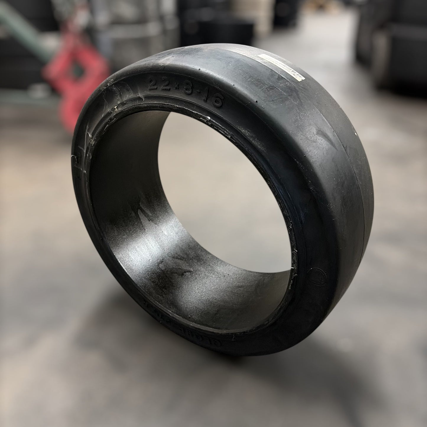 Black rubber bushing on a reflective surface with blurred background
