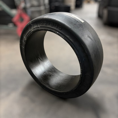 Black rubber bushing on a reflective surface with blurred background